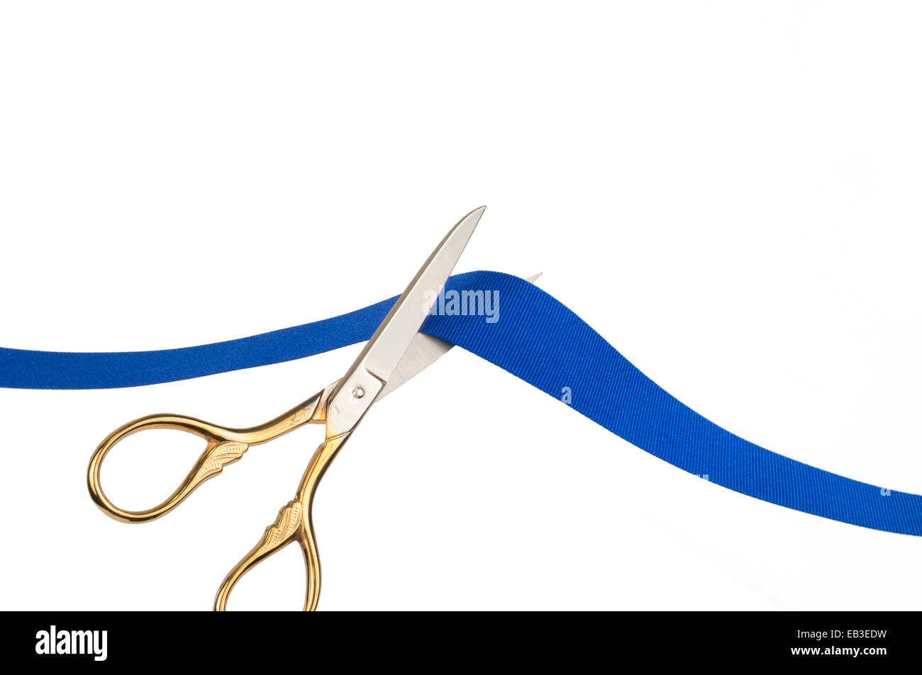 Scissors cutting a blue ribbon Stock Photo