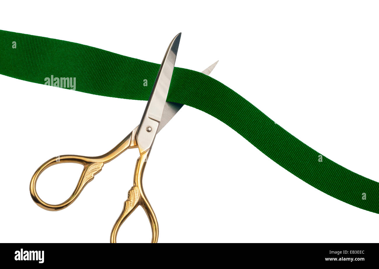 Scissors cutting a green ribbon Stock Photo Alamy