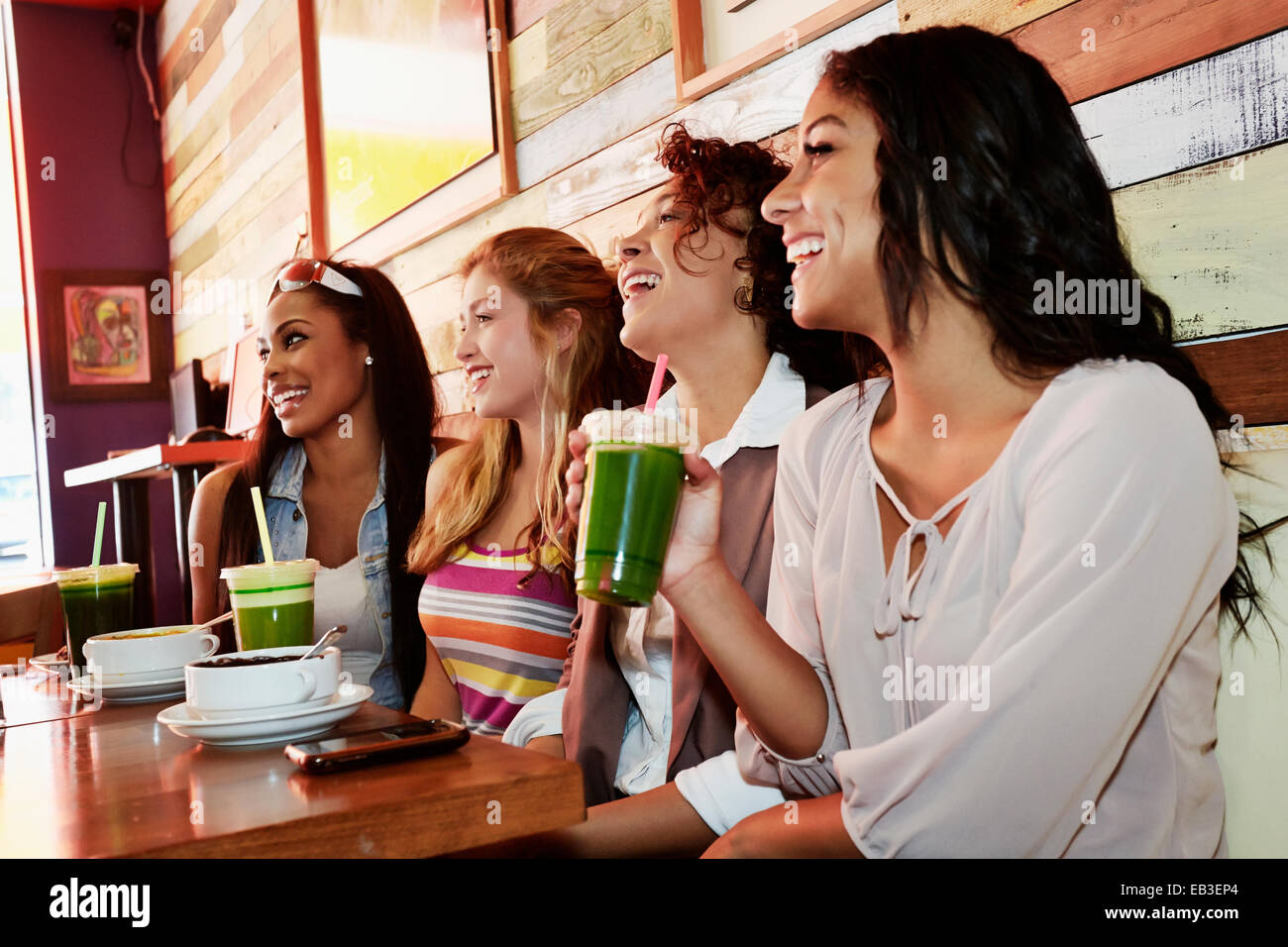 Women relaxing together in cafe Stock Photo