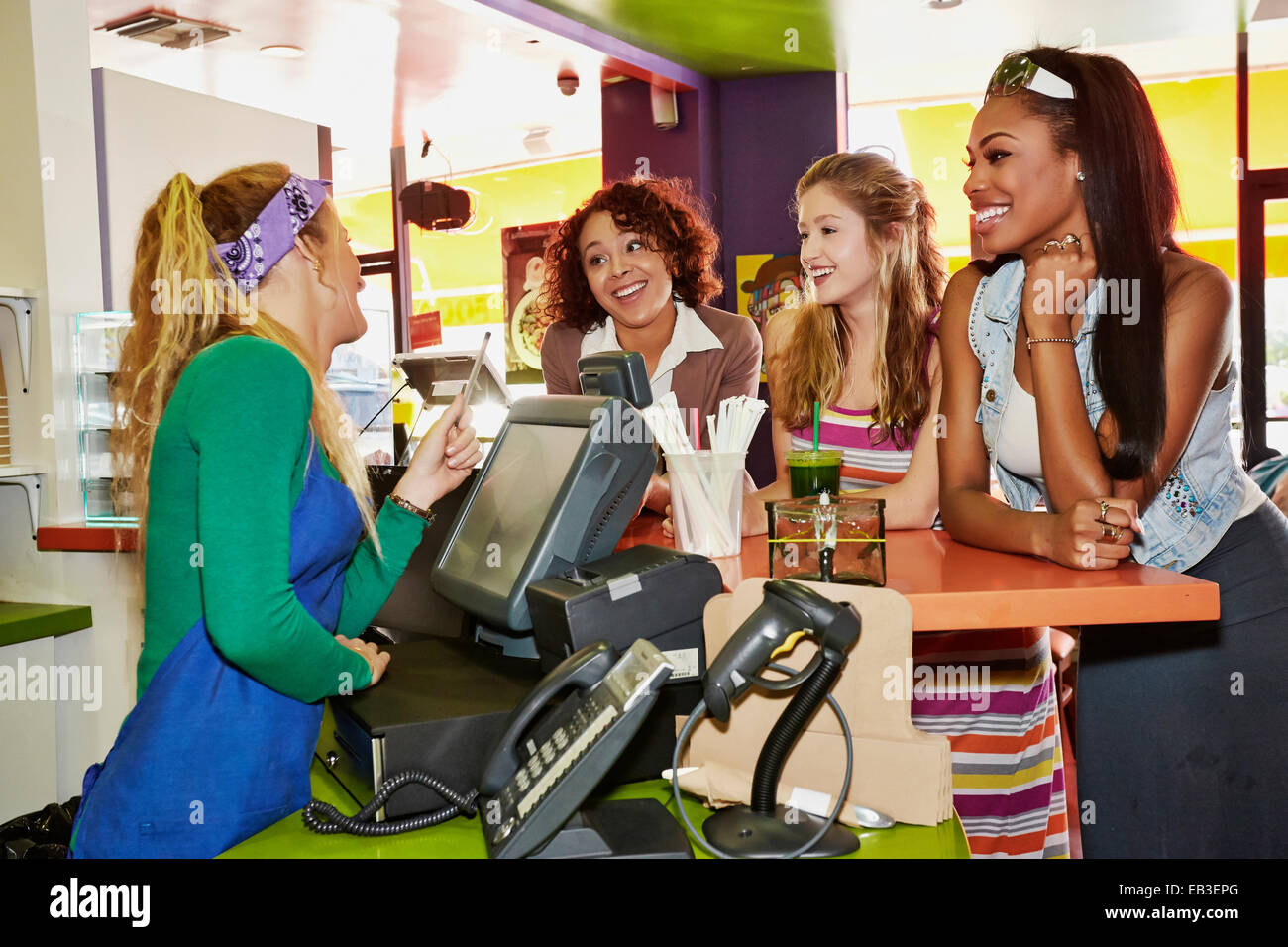 Women ordering from server in cafe Stock Photo