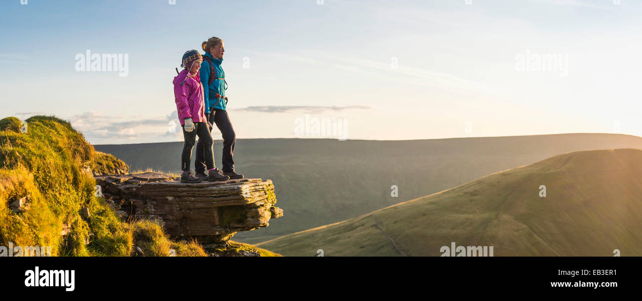 Panoramic view of hikers overlooking remote landscape Stock Photo