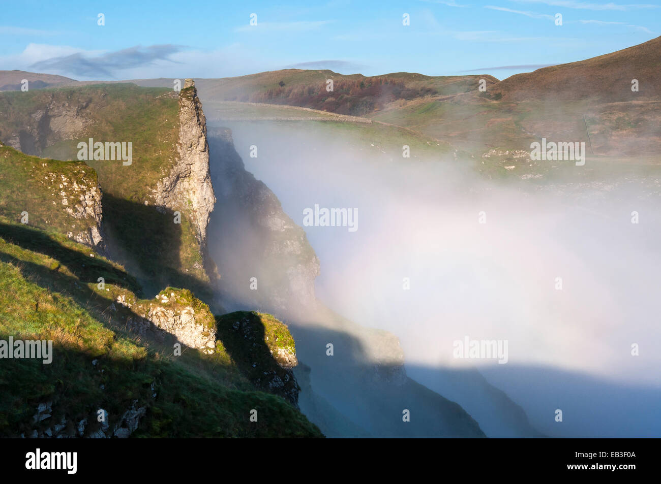Dramatic morning mist at Winnats Pass in the Peak District, Derbyshire. Looking toward Rushup edge. Stock Photo