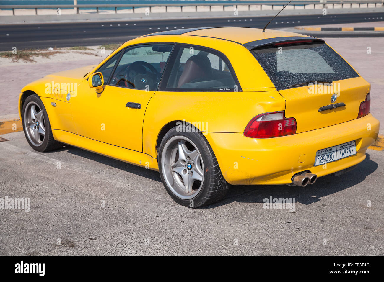 Manama, Bahrain - November 21, 2014: Yellow BMW Z3 M Coupe car stands parked on the roadside Stock Photo