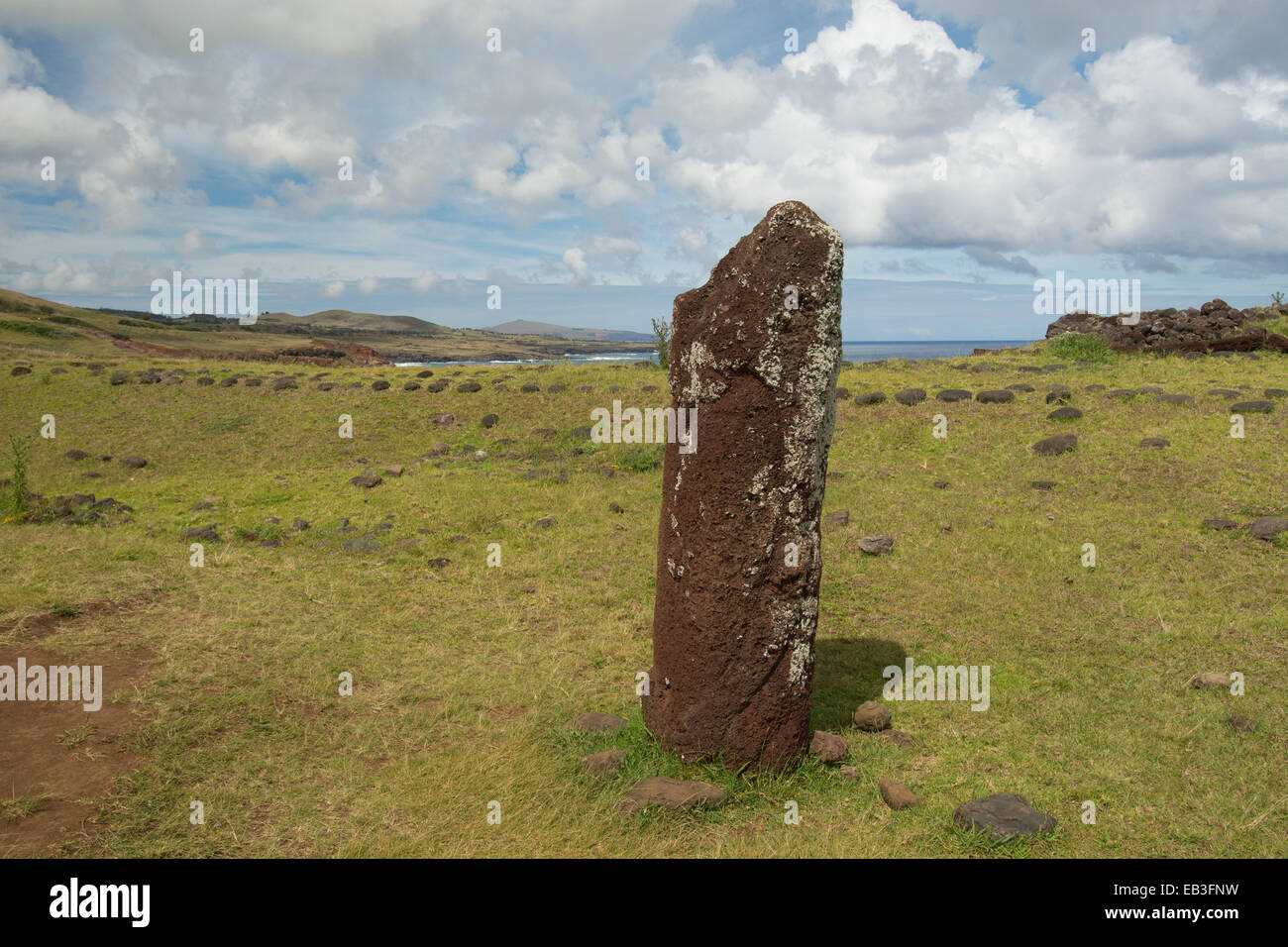Chile, Easter Island aka Rapa Nui, Rapa Nui NP. Ahu Vinapu. Red stone monolithic column thought to be a female moi. Stock Photo