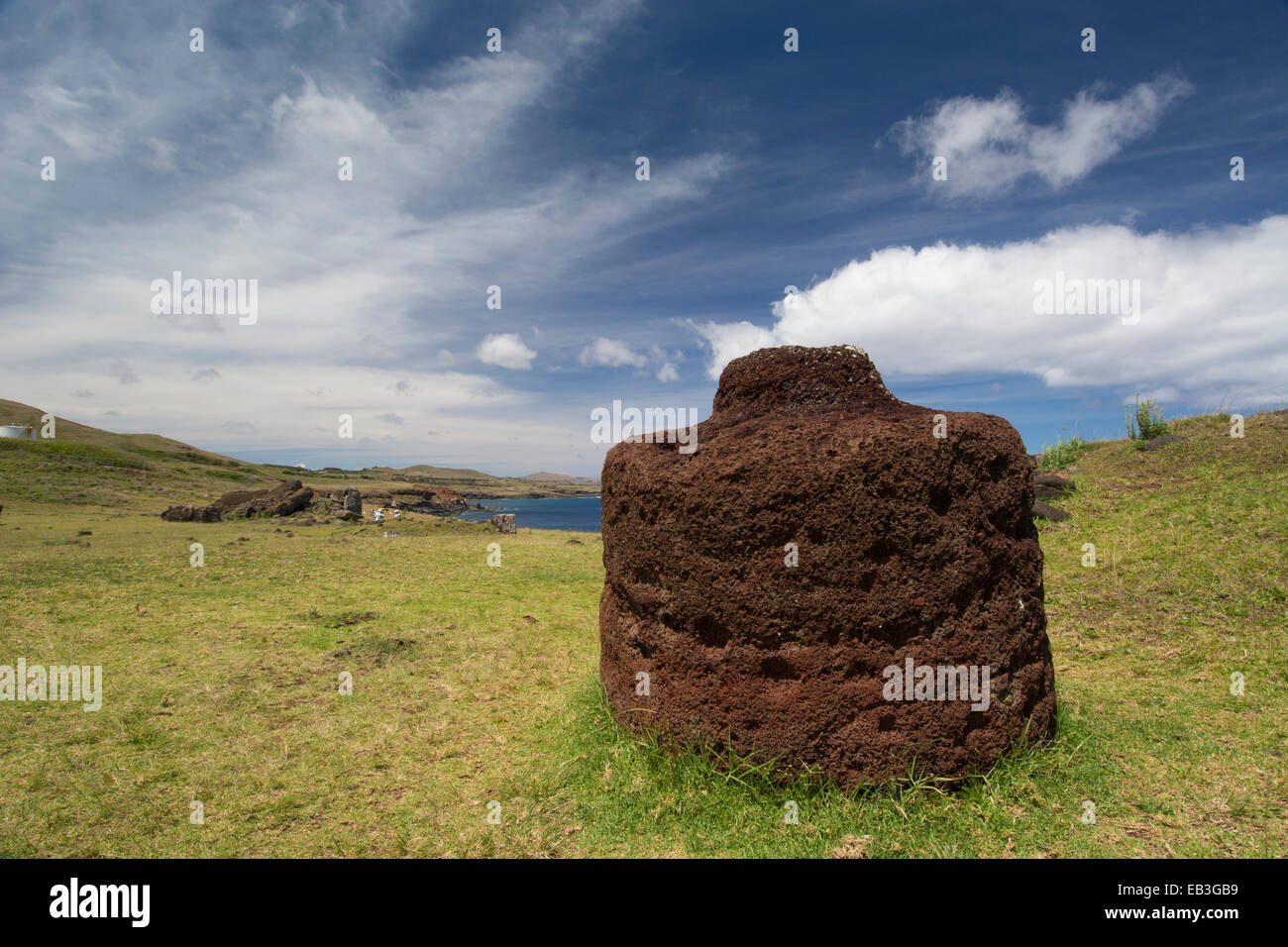 Chile, Easter Island aka Rapa Nui, Rapa Nui NP. Ahu Vinapu, important ceremonial center. Red volcanic scoria stone moi hat. Stock Photo