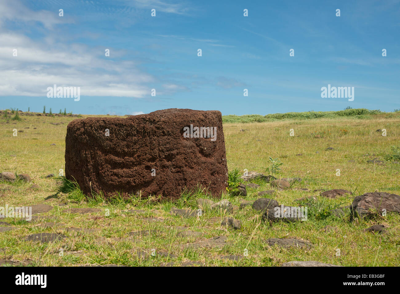 Chile, Easter Island aka Rapa Nui, Rapa Nui NP. Ahu Vinapu, important ceremonial center. Red volcanic scoria stone moi hat. Stock Photo