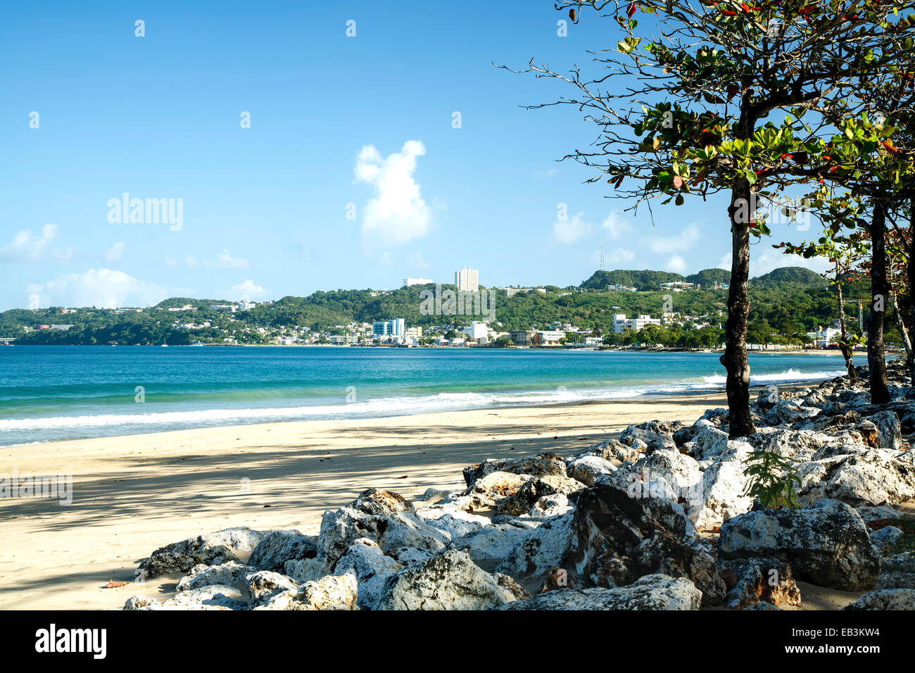 Beach, rocks and urban skyline, Aguadilla, Puerto Rico Stock Photo