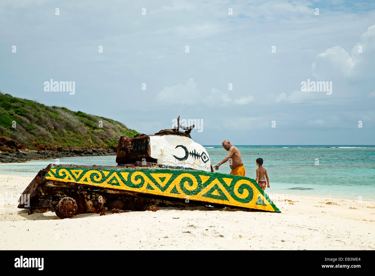 Man and boy looking at abandoned tank, Flamenco Beach, Culebra, Puerto Rico Stock Photo