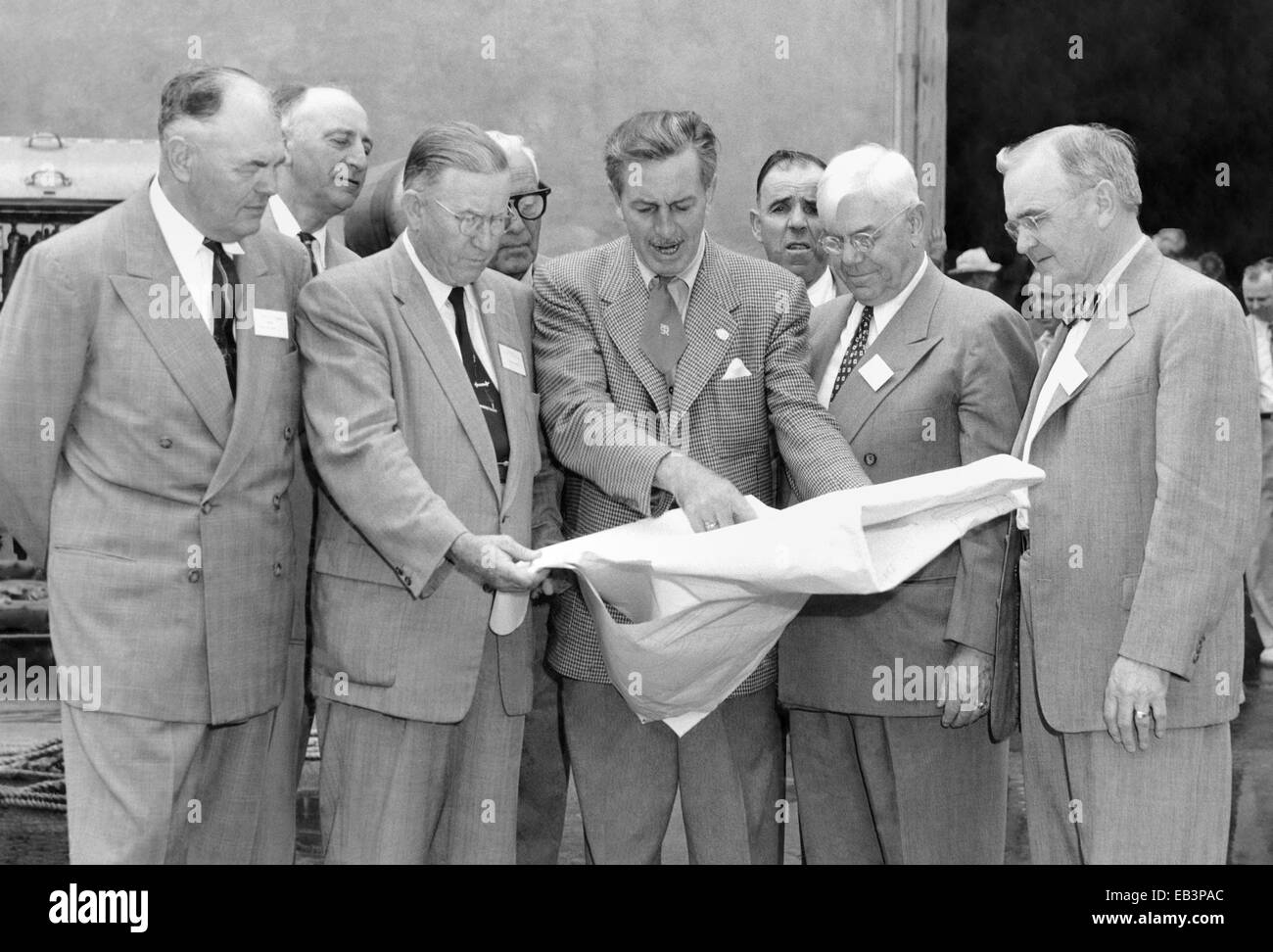 Orange County officials (left to right) Anaheim Mayor Charles Pearson, Orange County Supervisor Willis Warner, Supervisor Willard Smith, and Orange County Planning Commission Chairman Dr. W. L. Bigham study blueprints with Walt Disney (center) at Disney Studios December 1954 in Burbank, California. Walt Disney invited officials from Orange County to his studios to discuss his plans for creating Disneyland. Stock Photo