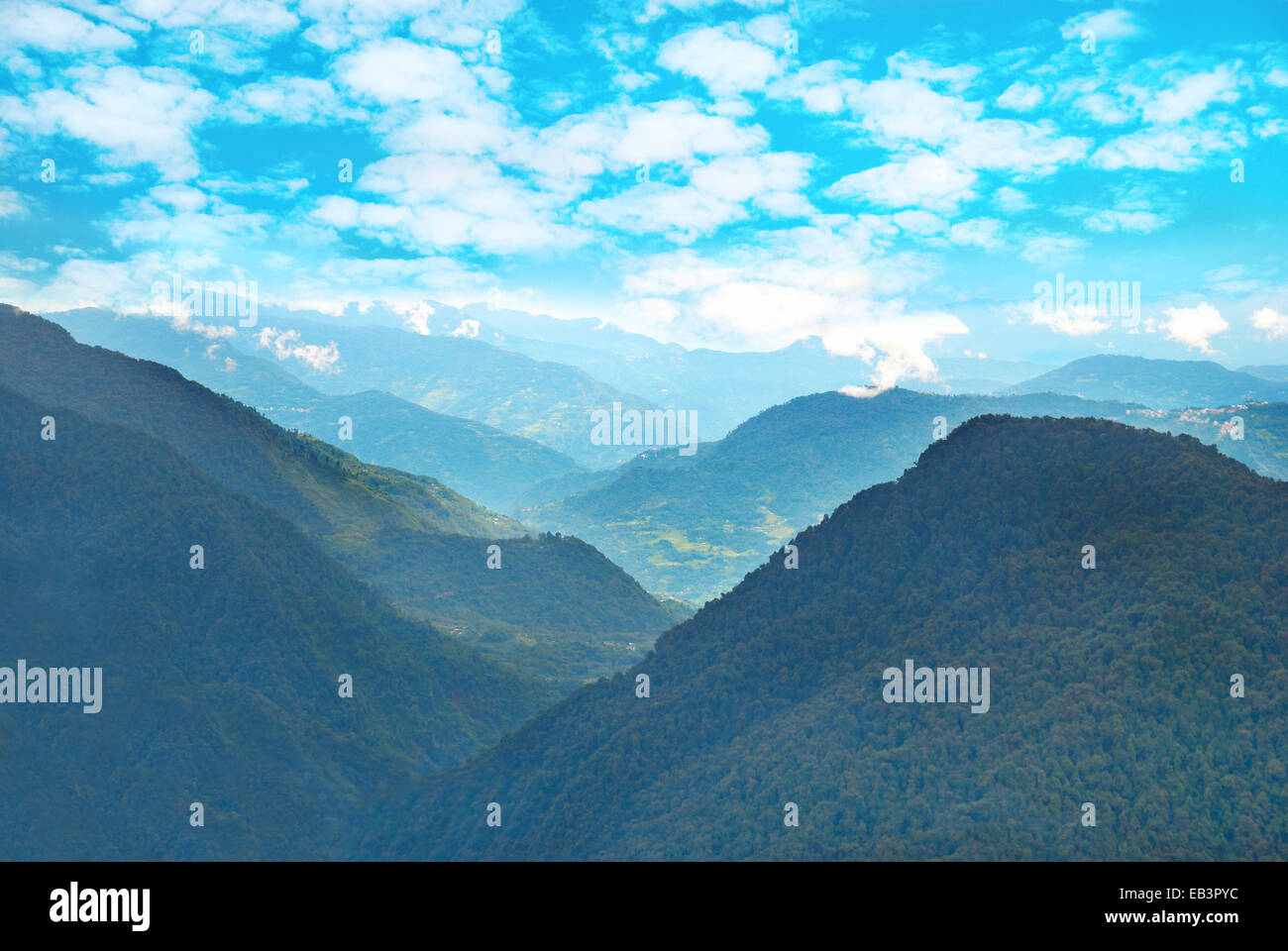 Green mountains with forest and blue cloudy sky Stock Photo - Alamy