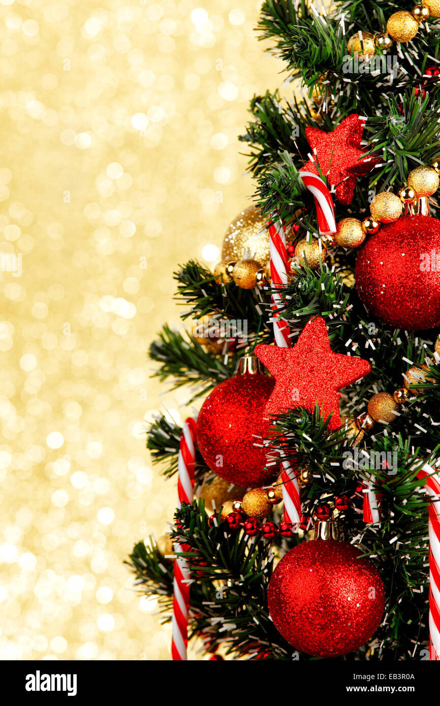 Beautiful decorated christmas tree on golden background Stock Photo - Alamy
