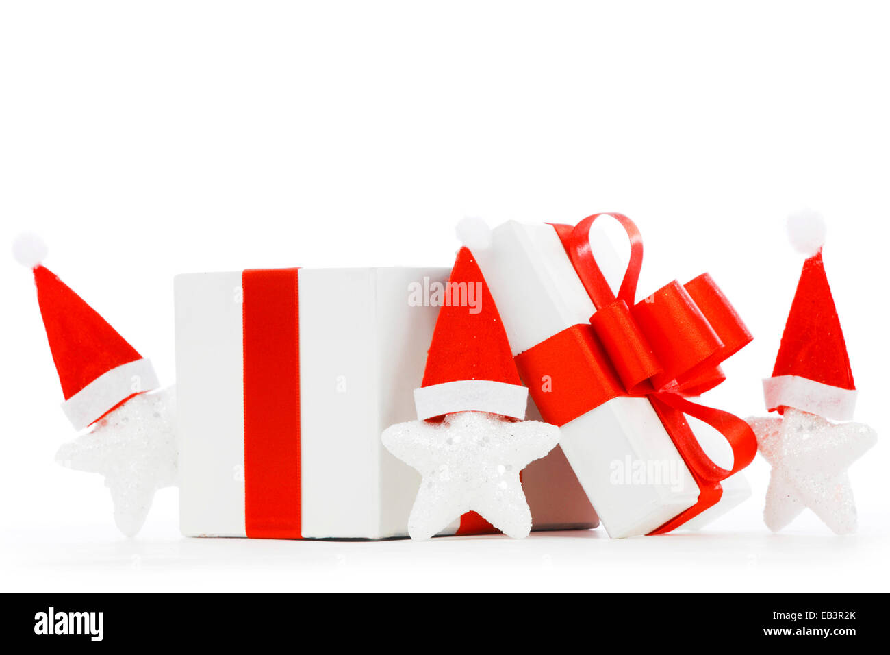 White gift box with red ribbon, stars with santa claus hats isolated on ...