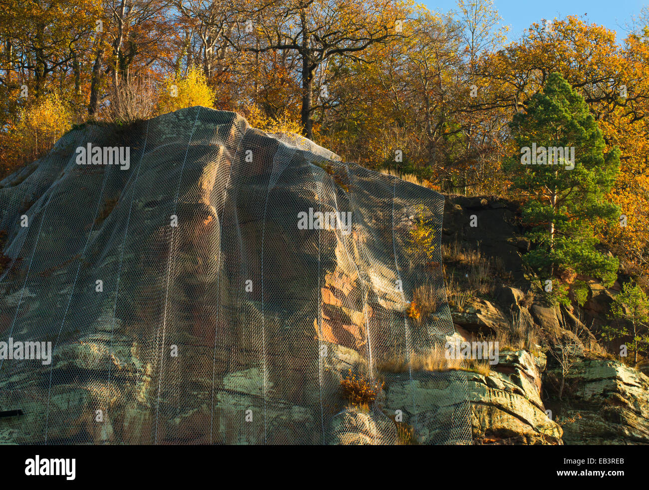 Metal netting covering High Rock, a sandstone cliff face, to prevent falling rock, Bridgnorth, Shropshire, England. Stock Photo