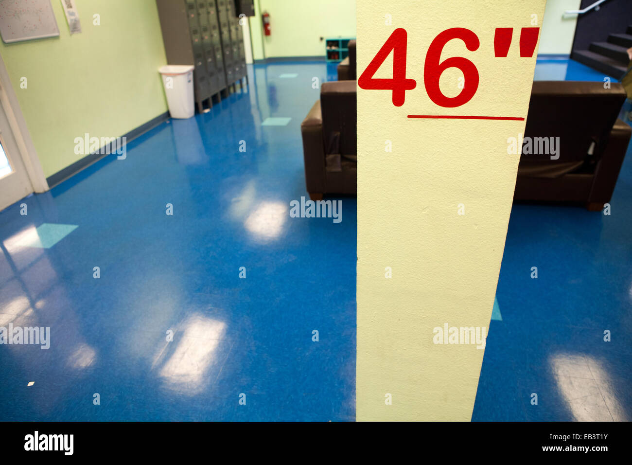Line on wall marking minimum height for participation, 46 inches. Stock Photo