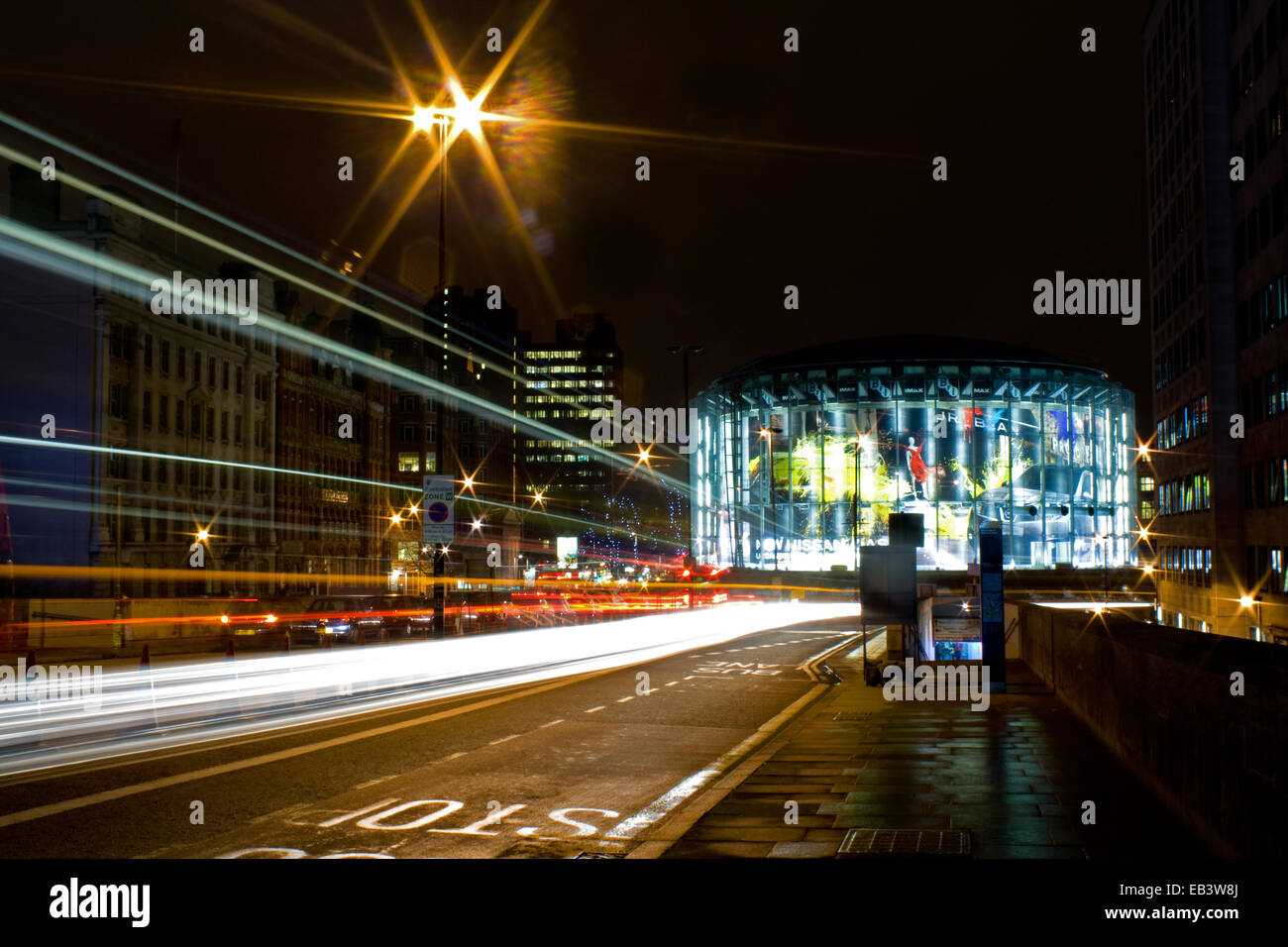 The IMAX Cinema at Waterloo, London at night with light trails Stock Photo