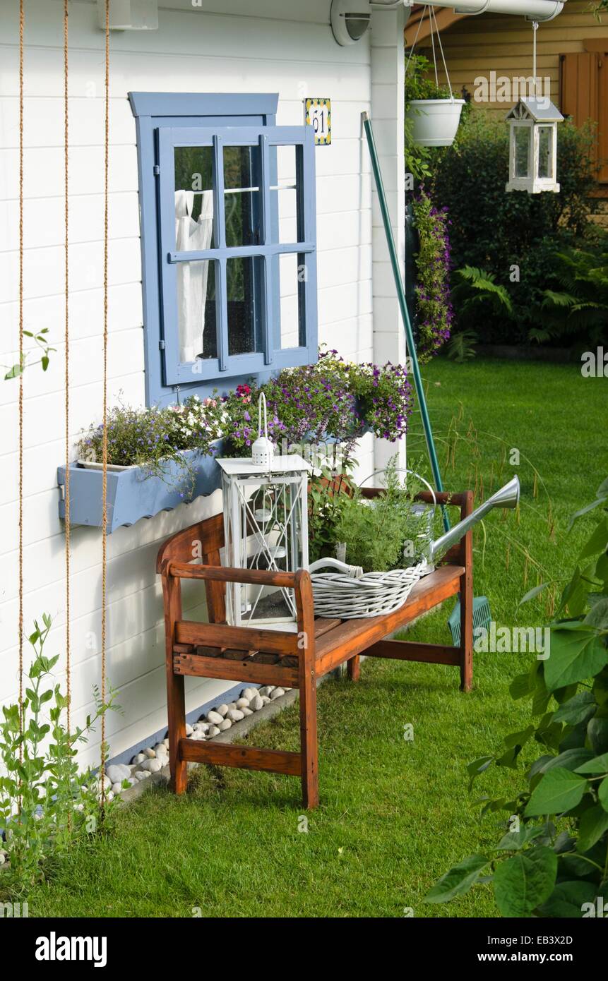 White garden house with bench Stock Photo