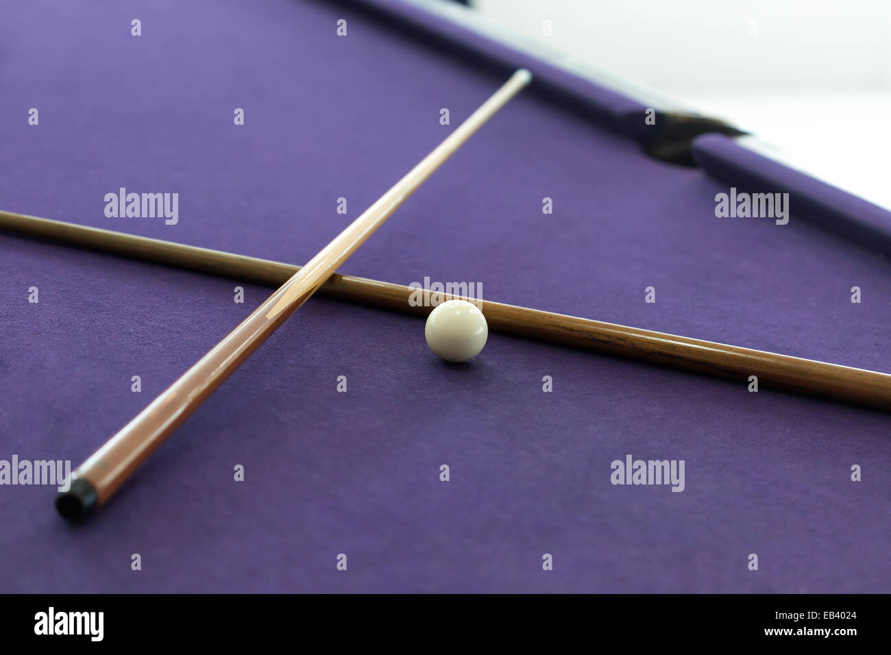 Billiard cues and white ball in pool table Stock Photo