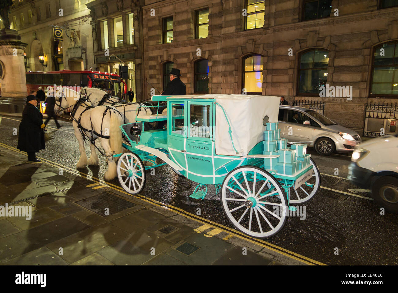 London, UK. 25th Nov, 2014. Two white shire horses pull a blue Tiffany & Co carriage through the streets of the City of London, UK.  The occasion was seasonal celebrations and festivities leading up to the switching on of the festive season Tiffany & Co Christmas tree illuminations on the steps outside the iconic Royal Exchange in the City of London by Sheriff Waddingham of the City of London, on Tuesday 25 November 2014. Credit:  Graham Prentice/Alamy Live News Stock Photo
