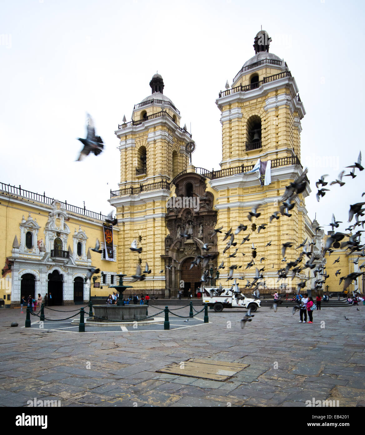 Pigeons in flight outside Basilica San Francisco in historic downtown Lima Peru Stock Photo