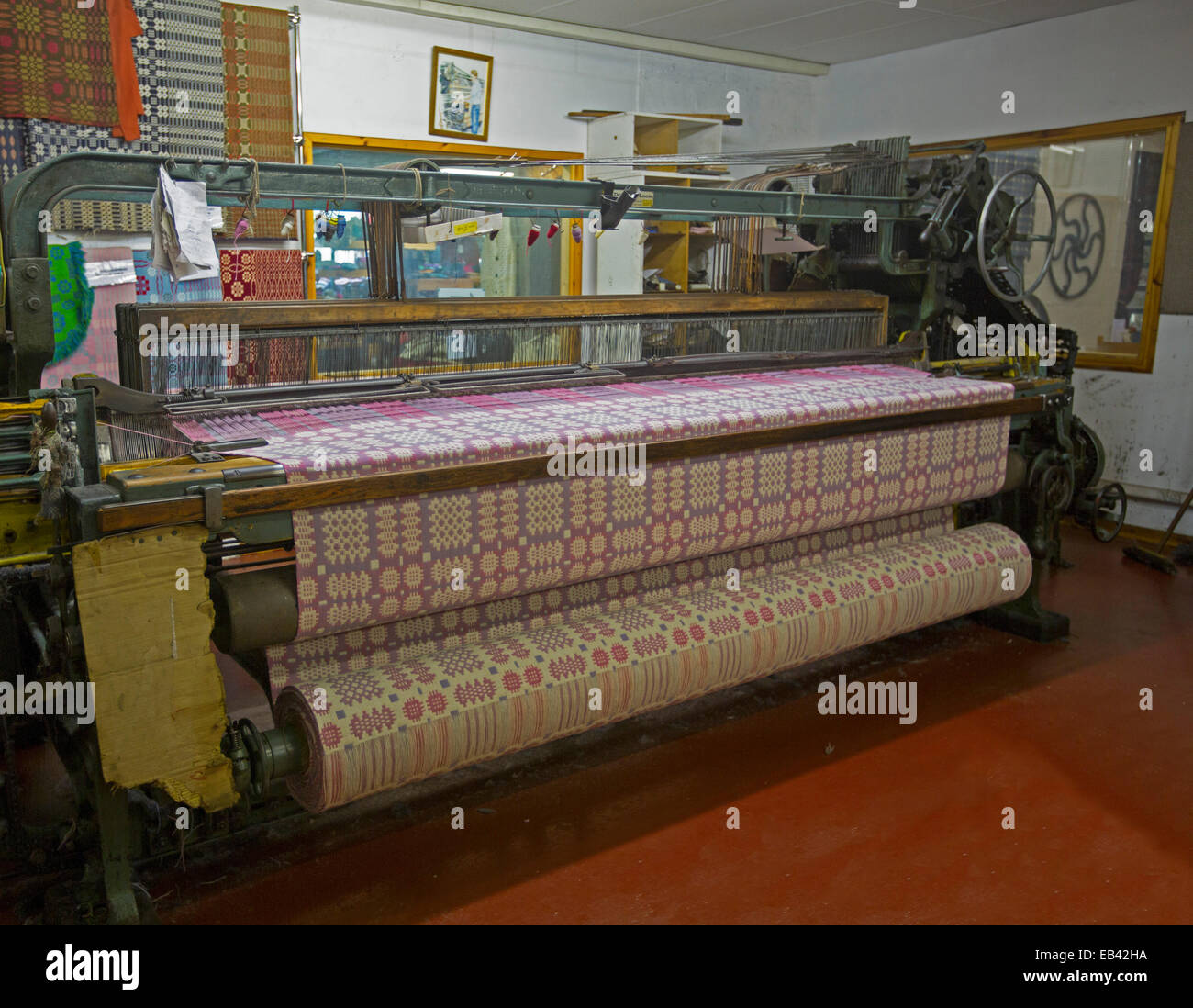 Large commercial loom with patterned fabric for bedspread being woven, Trefriw Woollen Mills, popular tourist attraction, Wales Stock Photo