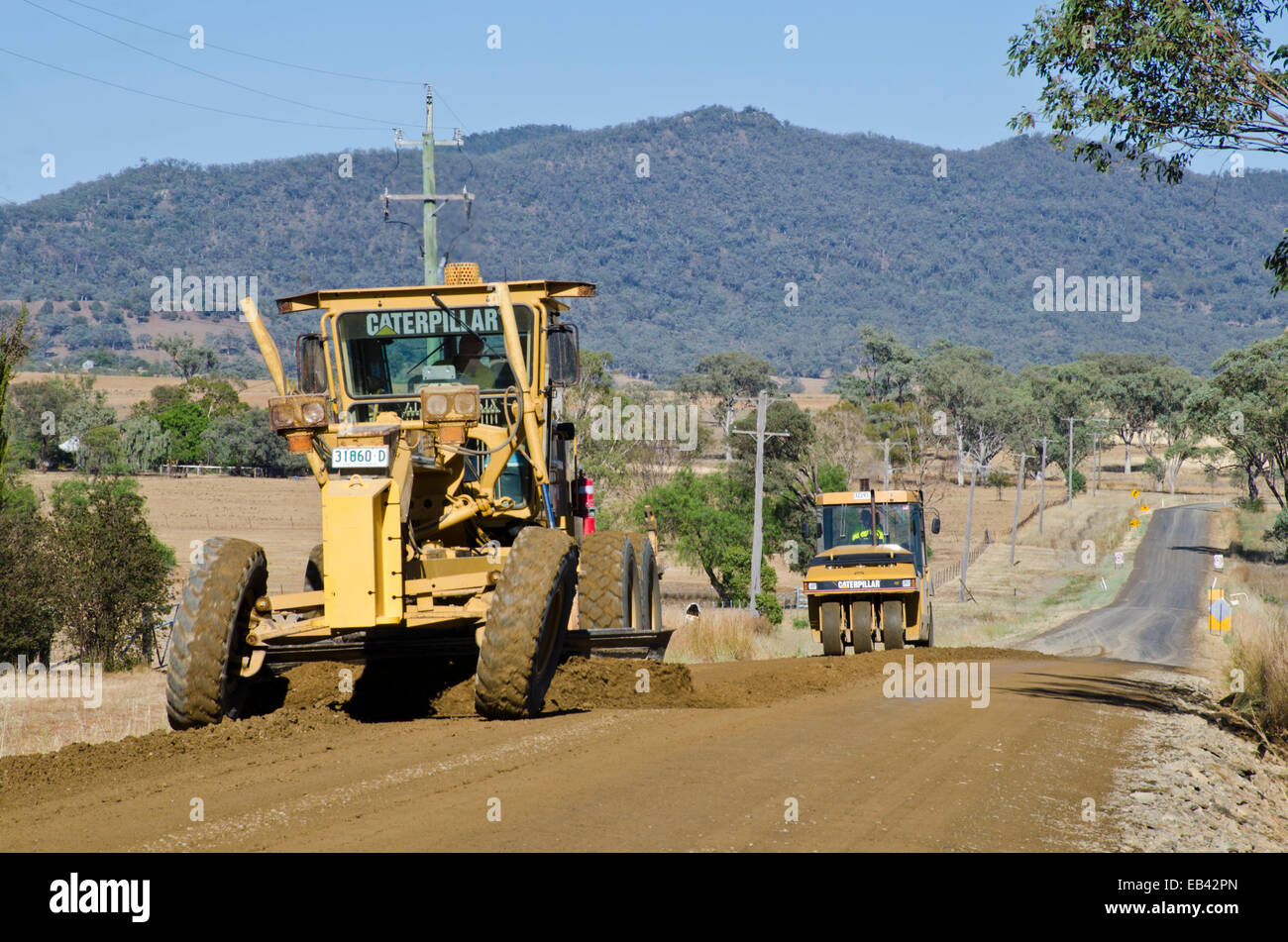 Grading and rolling a rural road preparing for resurfacing Stock Photo