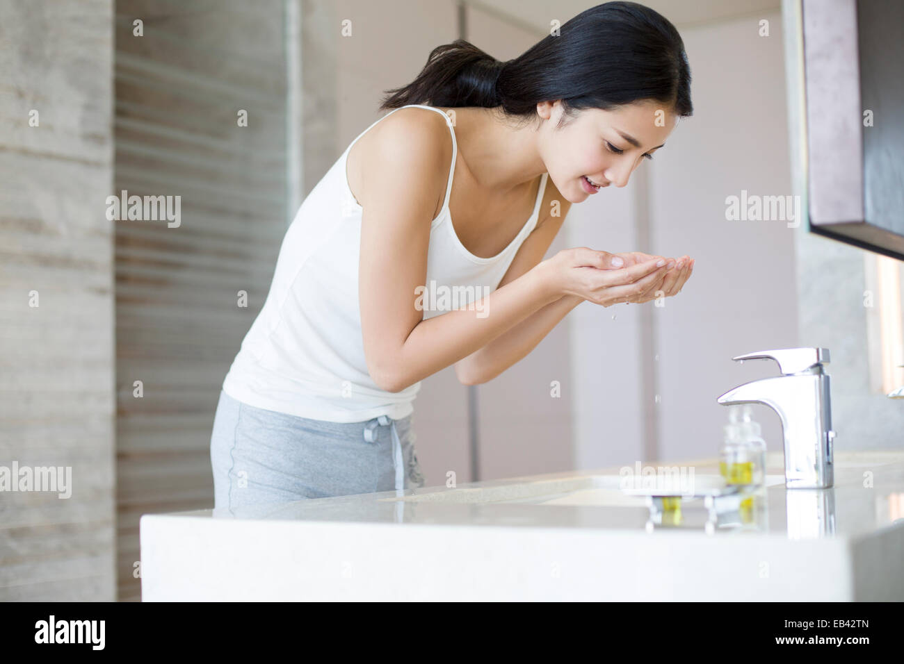 Young woman washing face Stock Photo