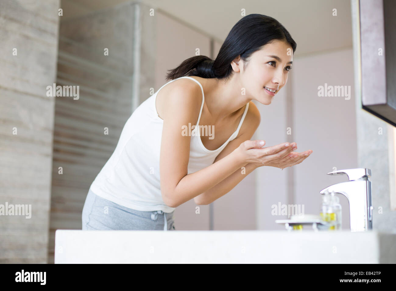 Young woman washing face Stock Photo