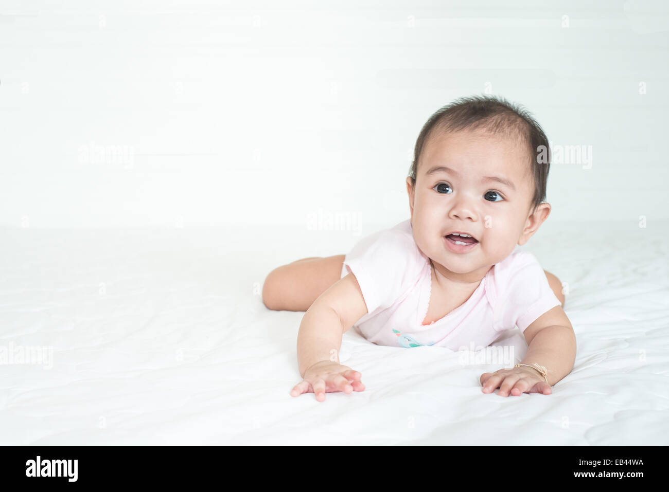 Asian cute girl baby crawling in bedroom Stock Photo