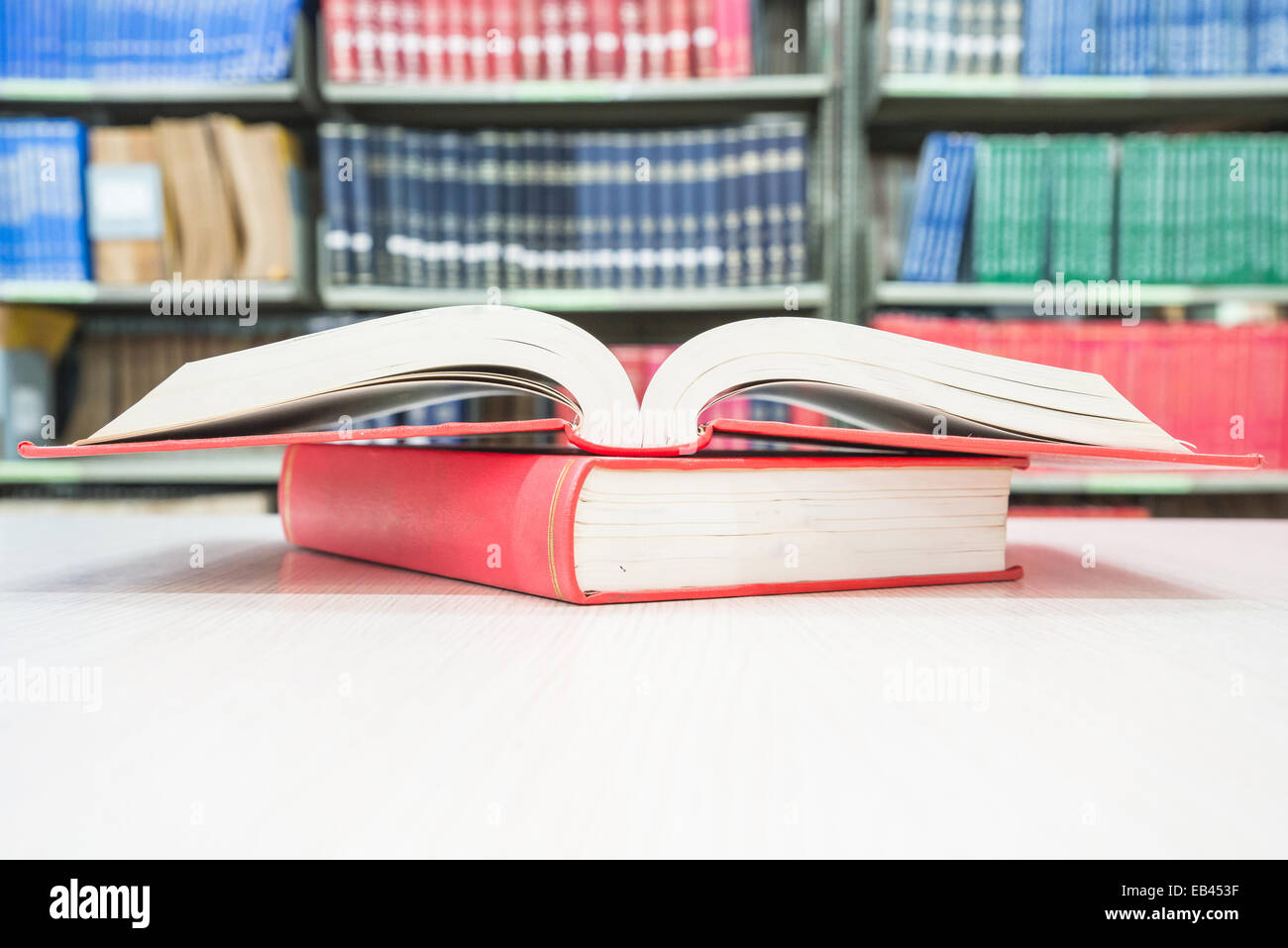 Open book on pile in library Stock Photo
