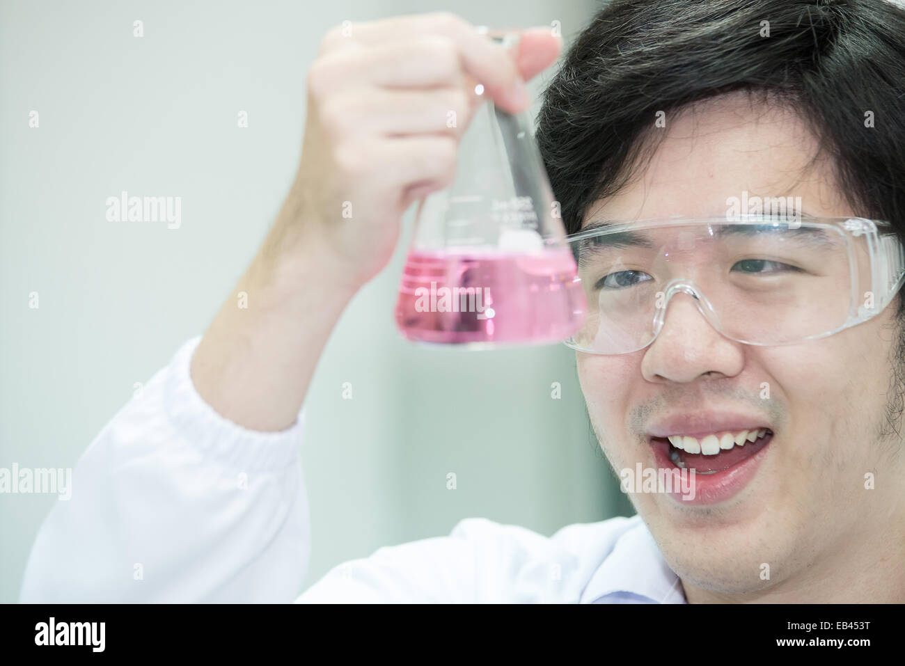 Asian researcher carrying out experiments in a laboratory - looking surprised Stock Photo