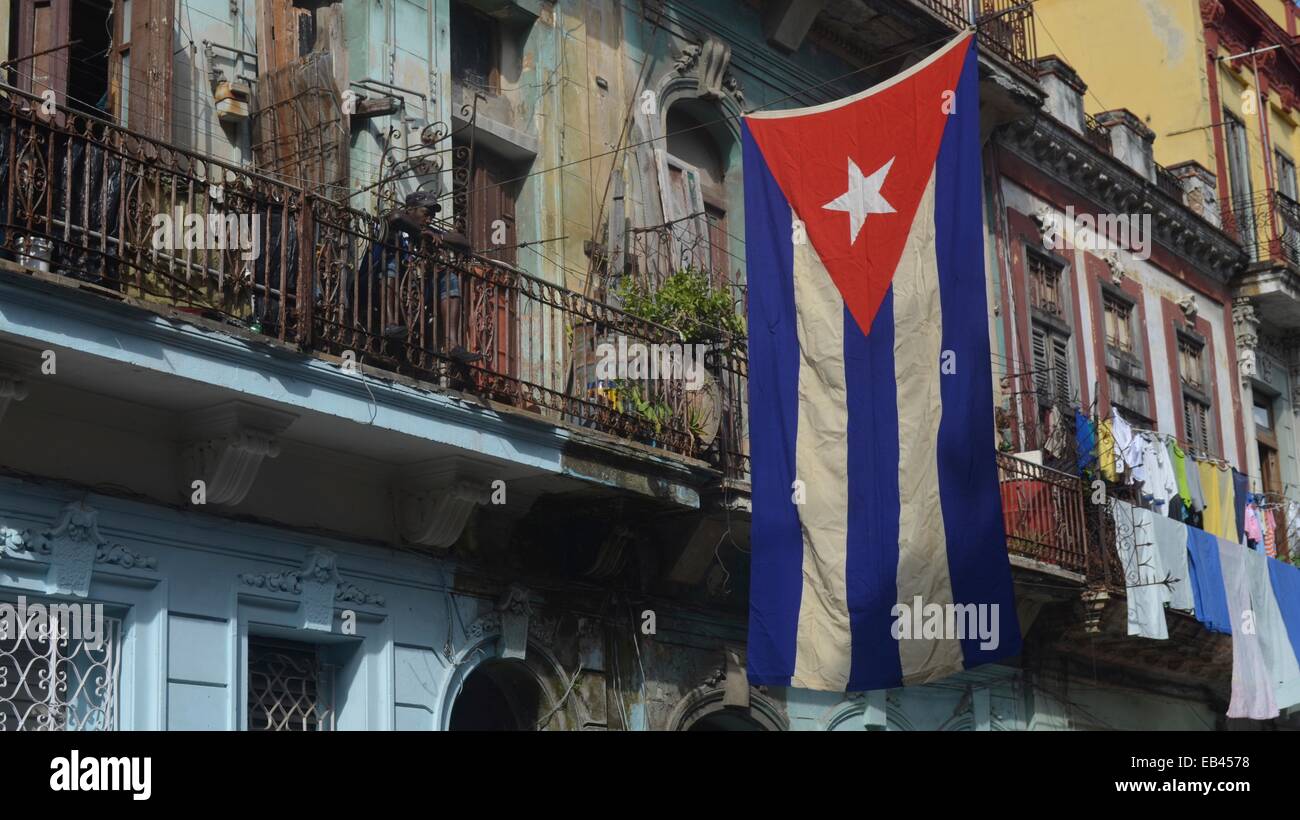 A Cuban Flag hangs over a residential street in Centro Havana Stock Photo