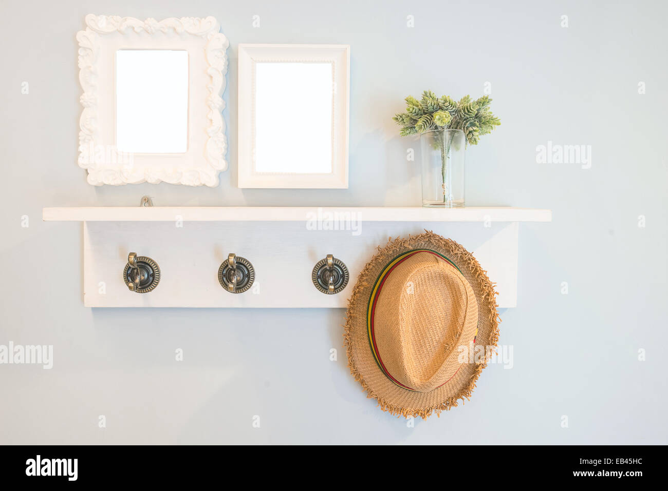 Hat hang on the  wall with picture frames Stock Photo
