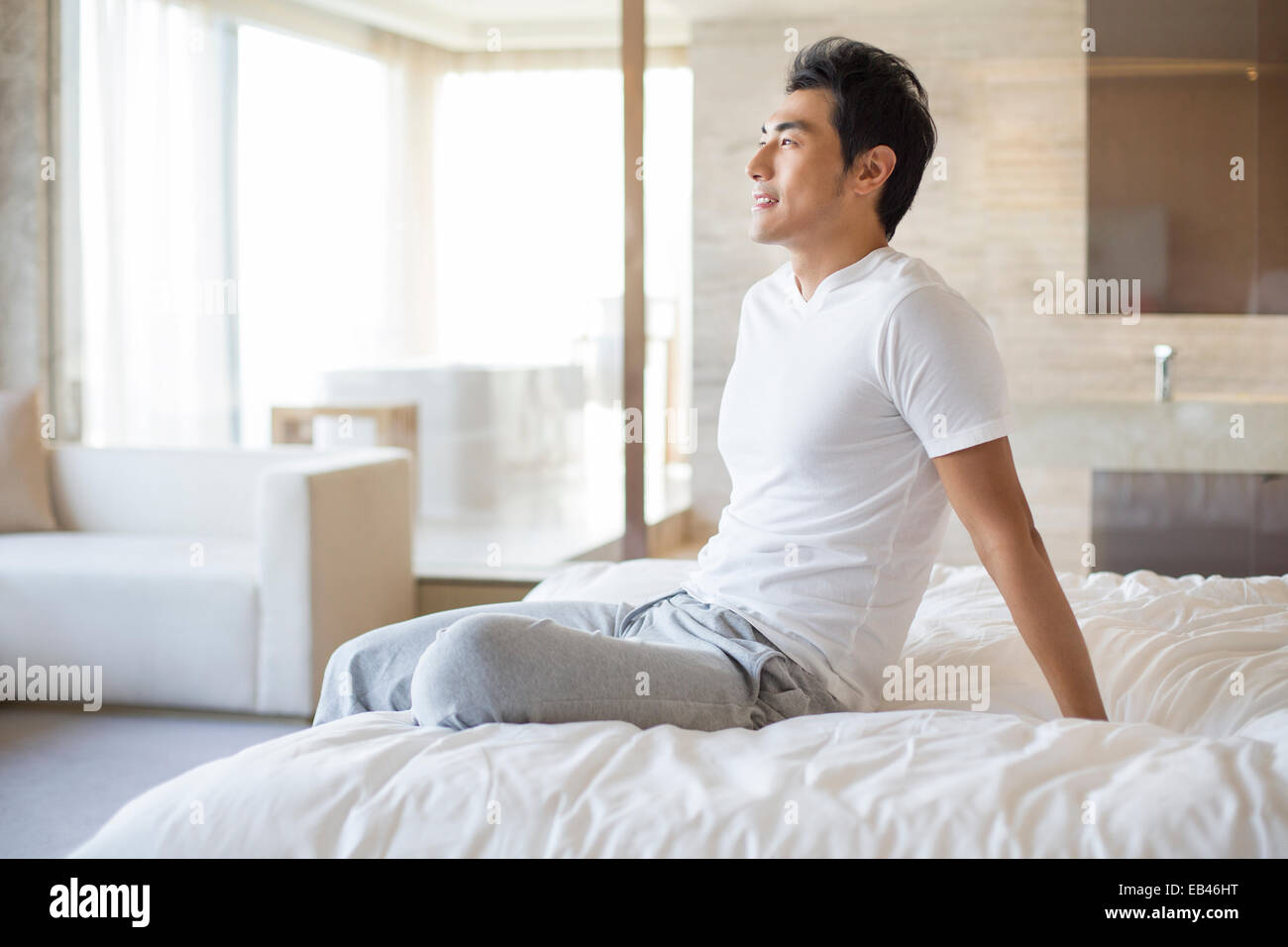 Young adult man thinking sitting hi-res stock photography and images ...