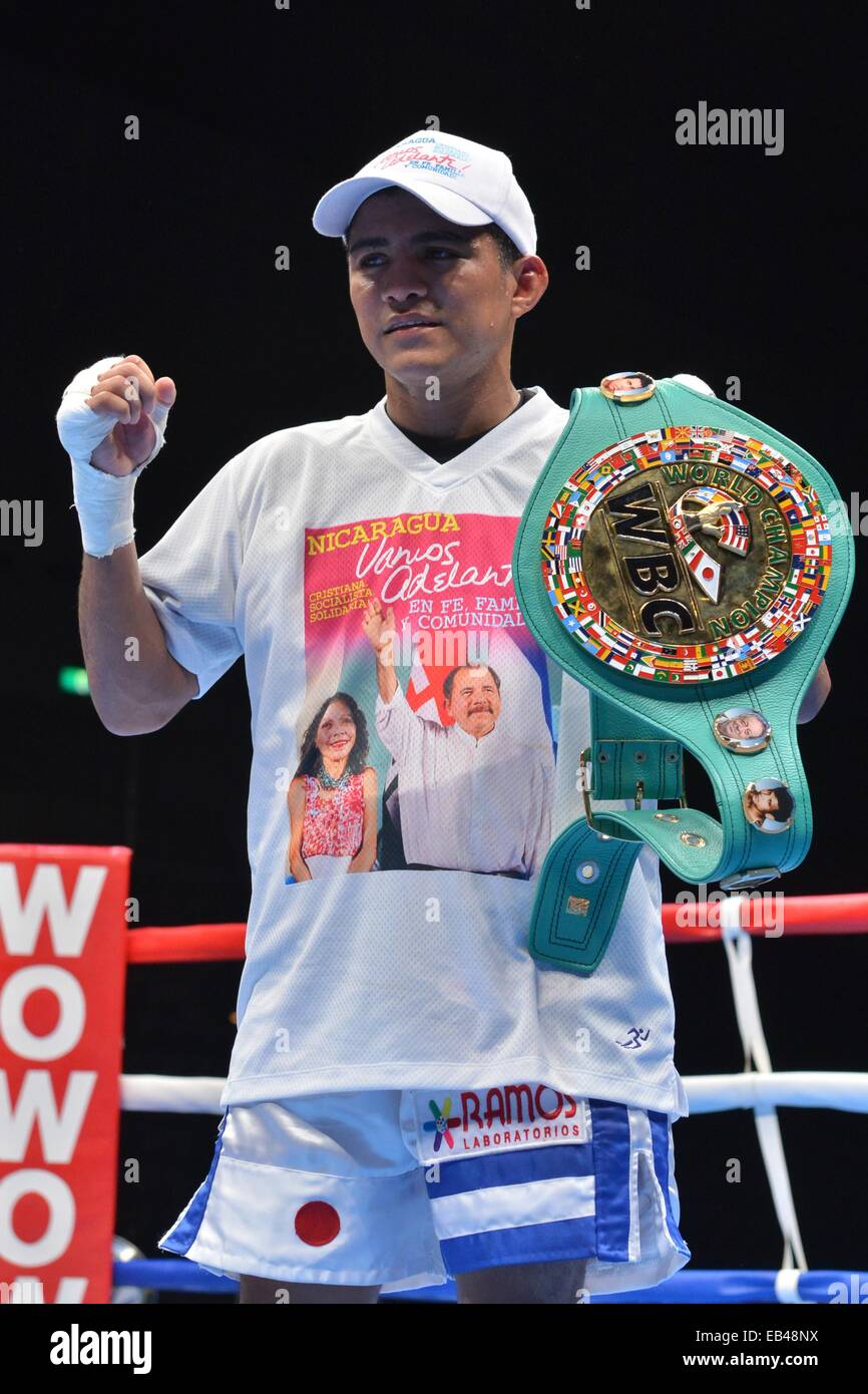 Kanagawa, Japan. 22nd Nov, 2014. Roman Gonzalez (NCA) Boxing : Roman Gonzalez of Nicaragua wears a t-shirt with the picture of Nicaragua's president Daniel Ortega and his wife Rosario Murillo as he celebrates with his champion belt after winning the WBC flyweight title bout at Yokohama International Swimming Pool in Kanagawa, Japan . © Hiroaki Yamaguchi/AFLO/Alamy Live News Stock Photo