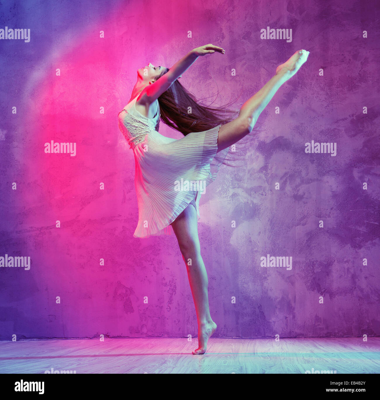 Flexible pretty ballet dancer on the dance floor Stock Photo