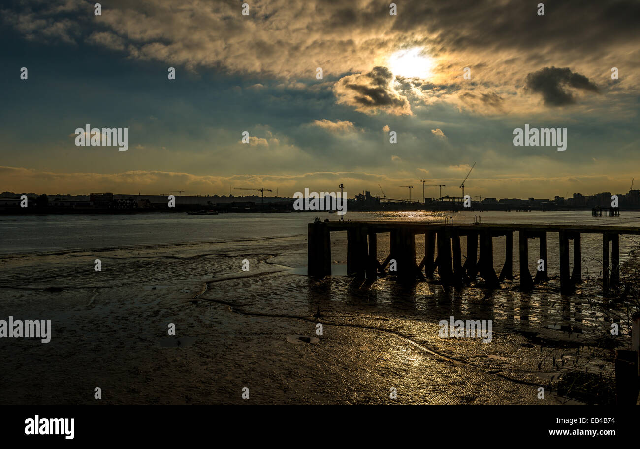 Tide out: sunset on the mud banks of the River Thames looking towards ...