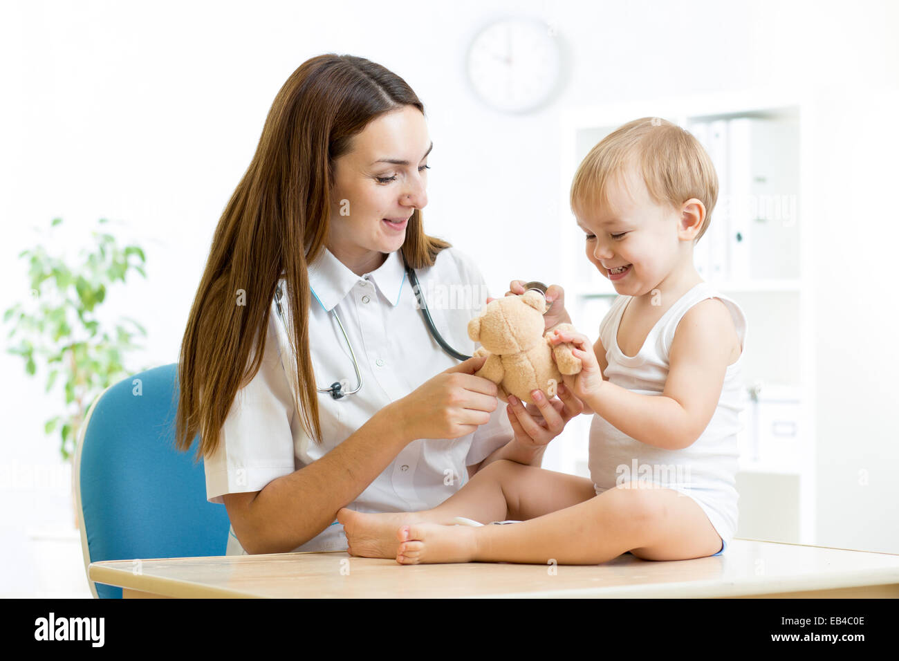 female pediatrician examining of child in hospital Stock Photo