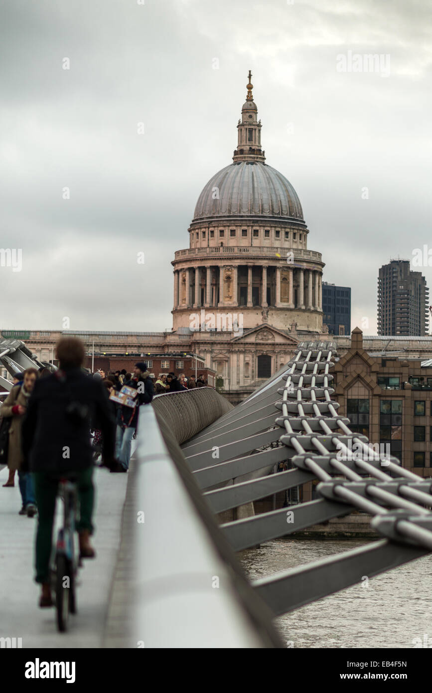 A cyclist and pedestians on the Millennium Bridge looking towards St Paul's Cathedra,l London Stock Photo