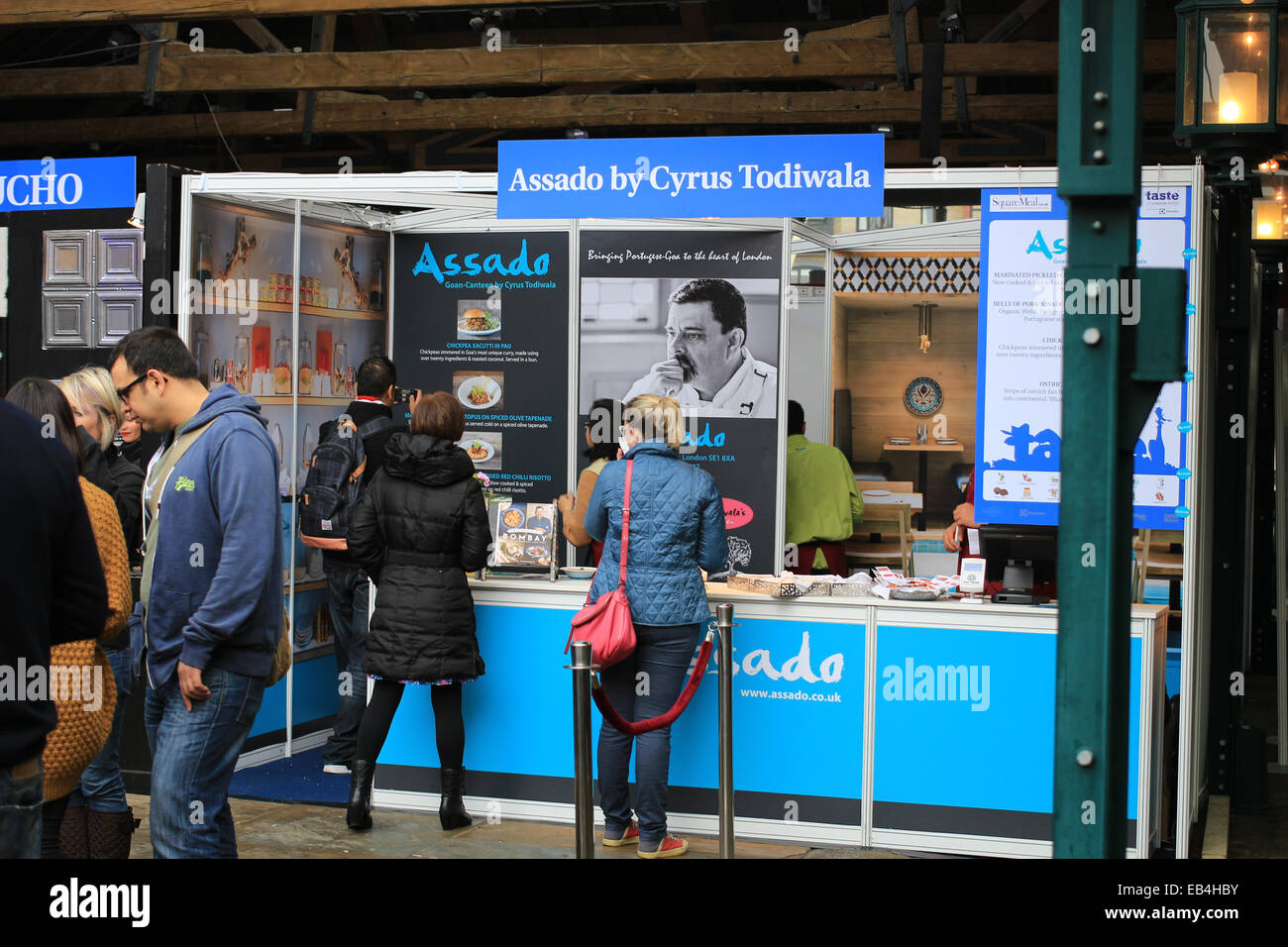 Assado by Cyrus Todiwala food stand at Taste of London Winter, Tobacco Dock,  London Stock Photo - Alamy