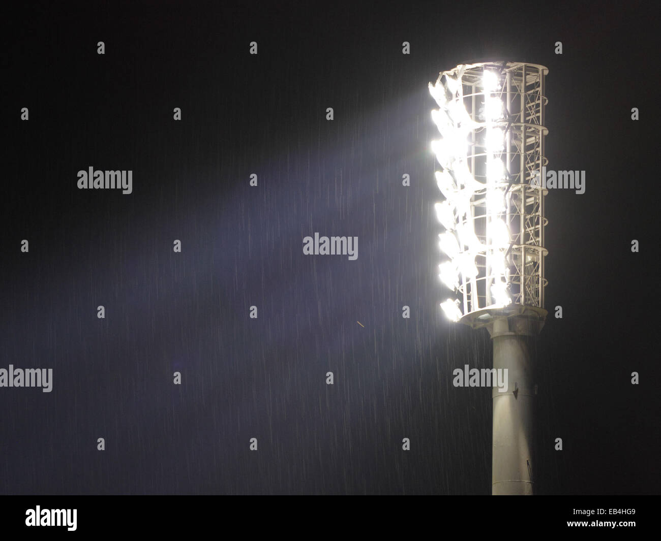 Stadium Floodlights glowing in the night Stock Photo