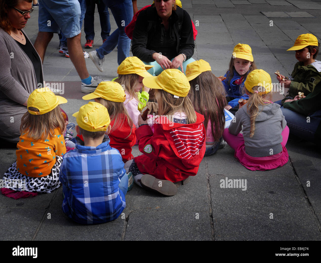 Germany Munich Marienplatz Kindergarten Kids on floor having sandwiches lunch Stock Photo