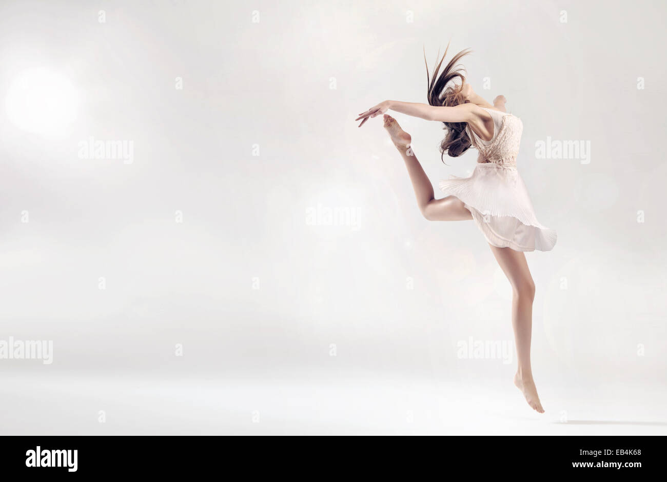 Pretty female ballet dancer in hard jump figure Stock Photo Alamy