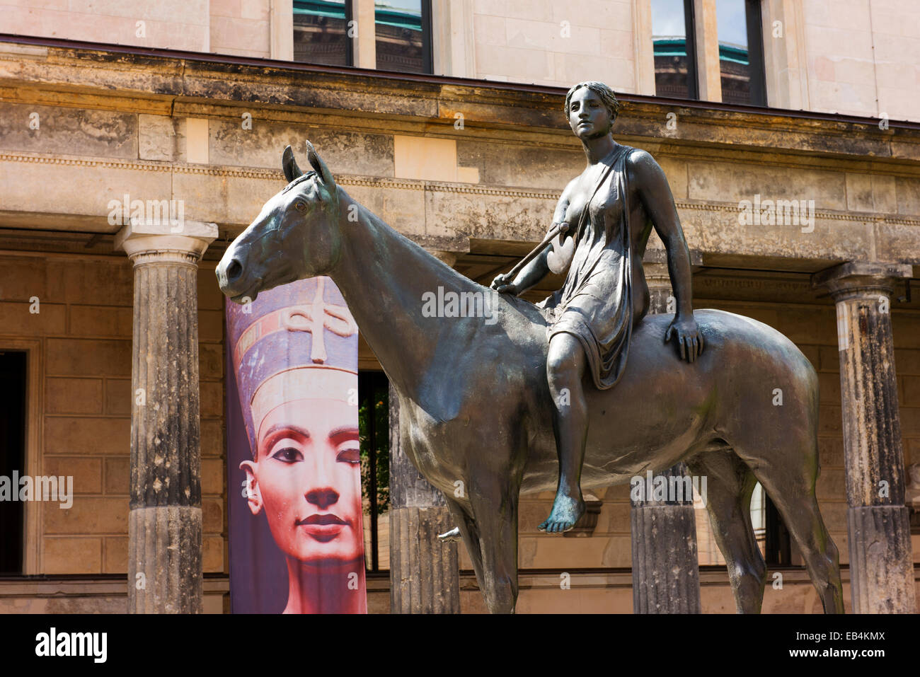 Bronze statue of a woman on a horse and a banner depicting the antiquities exhibit near the entrance to the Pergamon Museum. Stock Photo
