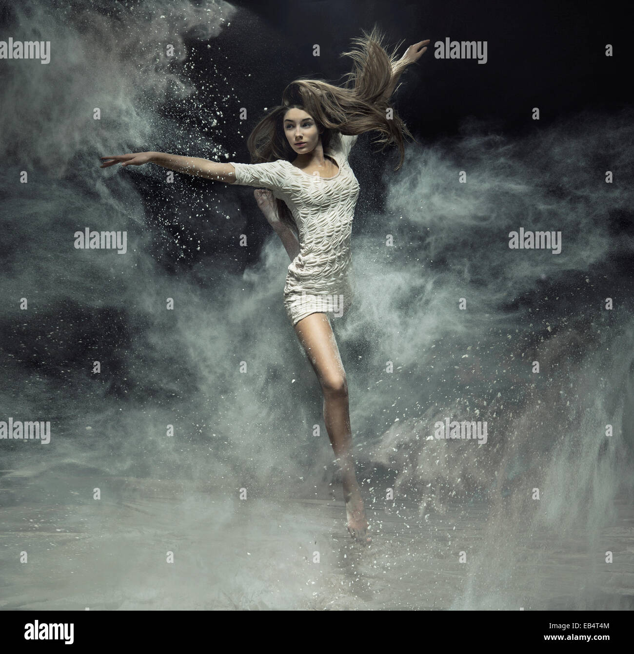 Talented ballet dancer catching the white dust Stock Photo