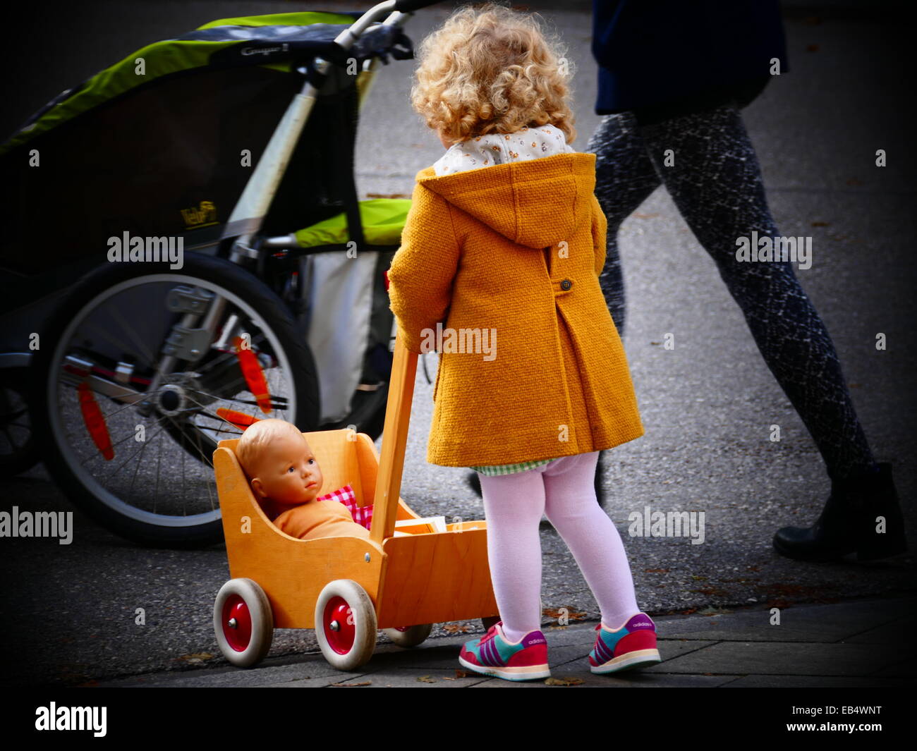 High Fashioned Little Girl Pushing Toy Baby In Babywagon With Mother Stock Photo Alamy