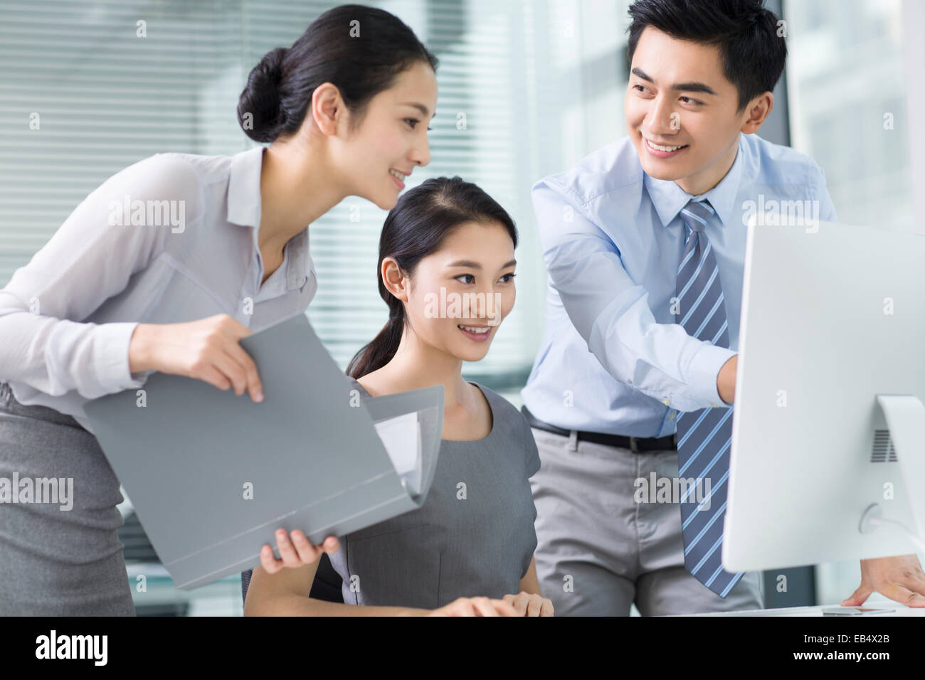 Young business people using computer in office Stock Photo - Alamy