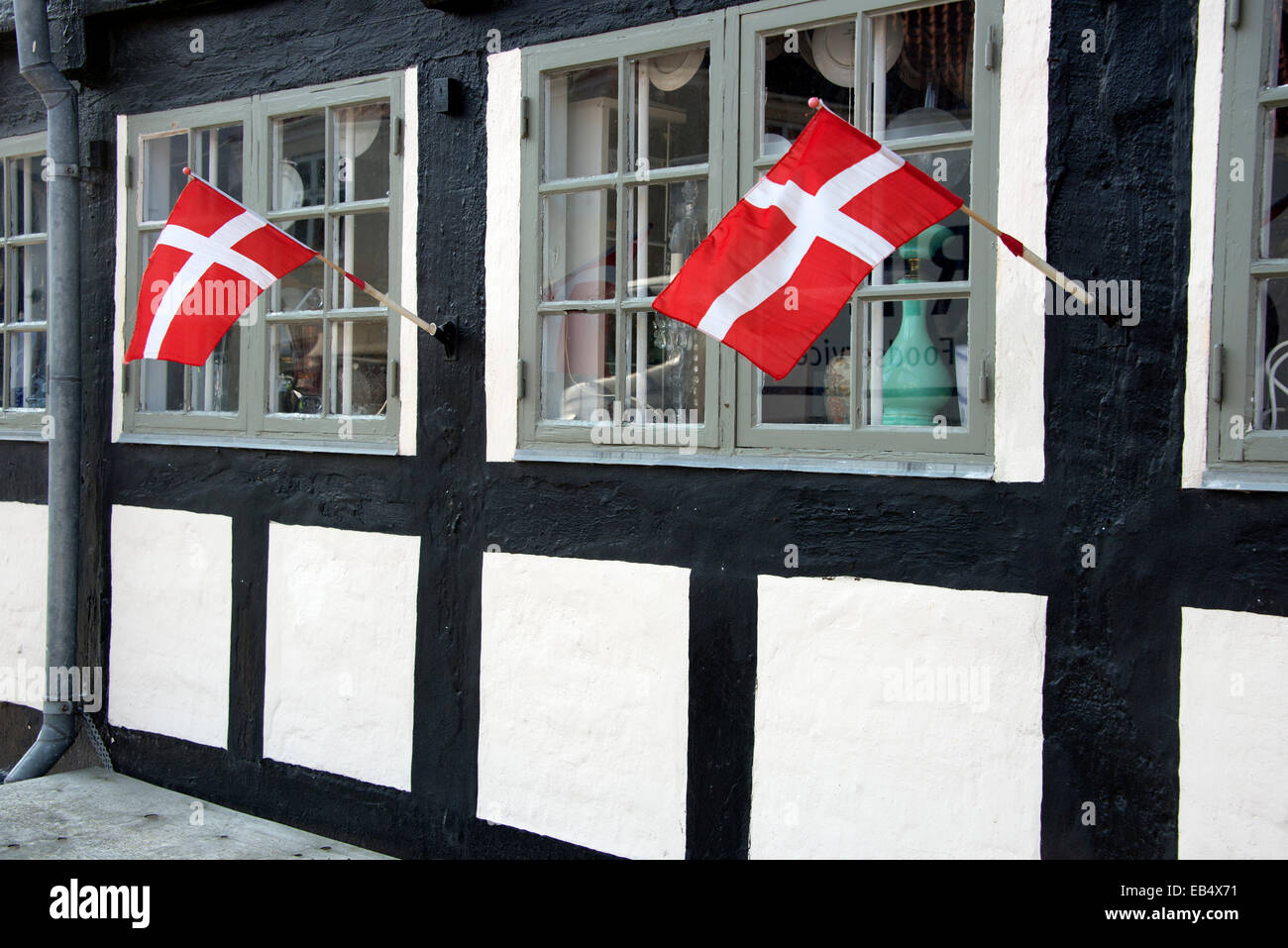 Two Danish flags hung out at a restaurant in  Ebeltoft, East Jutland in Denmark Stock Photo
