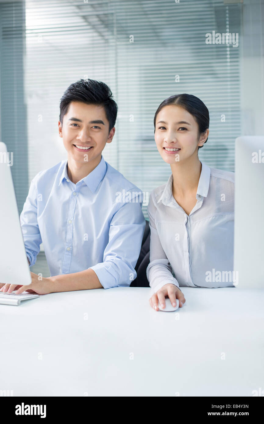 Portrait of young businessman and businesswoman in office Stock Photo