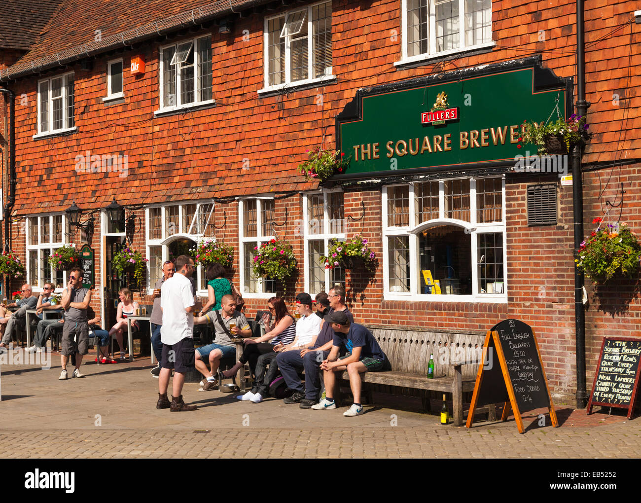 Drinkers in the sunshine outside the Square Brewery Pub in Petersfield Stock Photo
