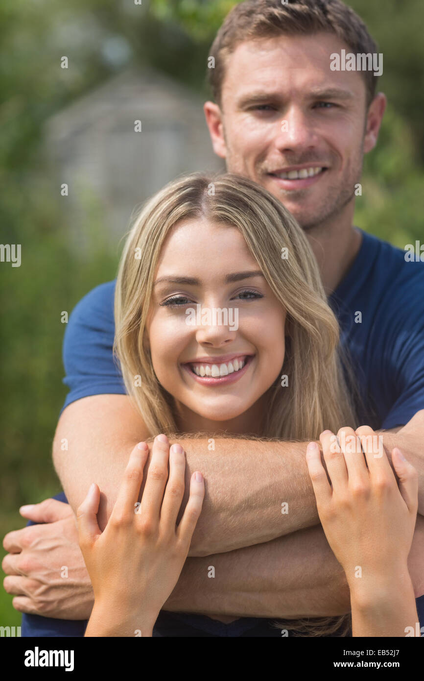 Cute couple smiling at camera Stock Photo - Alamy